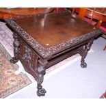 A 19th century carved Cuban mahogany library table with frieze drawer over undertier, on panel end