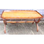 A yew wood gallery top coffee table, on 'X' frame stretchered supports, 42 1/2" wide