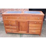 A polished as mahogany sideboard with inset marble top over two long drawers and two cupboards,