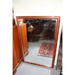 A polished as mahogany framed bevelled edge wall mirror, 36" x 24"