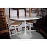 An Eero Saarinen for Knoll white laminate tulip table and a pair of tulip chairs