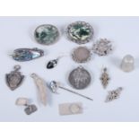 Two silver mounted moss agate brooches, two silver medallions, a silver brooch, formed as a kukri,