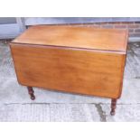 A 19th century mahogany Pembroke table, fitted two drawers, on turned and castored supports, 35"