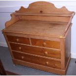 A late 19th century waxed pine ledge back dressing chest of two short and two long drawers, on stile
