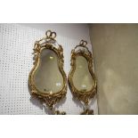 A pair of 19th century gilt framed pear-shape wall mirrors with swag and bow decoration