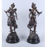 Par Guillemin: a pair of patinated spelter figures, women holding instruments, on ebonised wooden