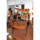 A 19th century mahogany panel seat armchair with scrolled arms and turned supports and a 19th