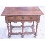 An early 18th century oak side table, fitted one drawer, on turned and stretchered supports and