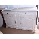 A French carved white painted sideboard, fitted two drawers, on shaped supports, 63" wide