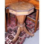 A late Victorian walnut octagonal work table, with fitted silk interior, on tripod splay castored