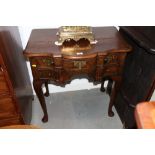 A 19th century mahogany serpentine low boy of Queen Anne design, fitted central drawer flanked two