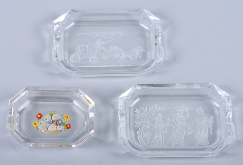 Two early 20th century French glass ash trays with etched decoration of classical scenes and another