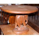 A teak oval occasional table, on elephant support, 23" wide
