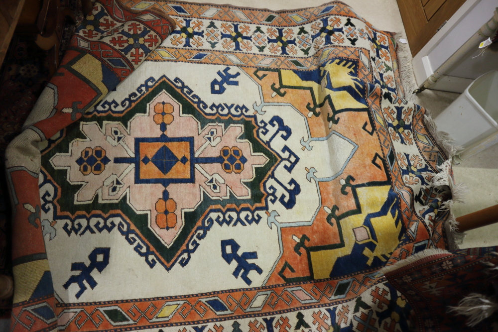 A Kazak design rug with central design medallion on a cream ground, 78" x 110" approx