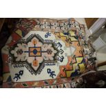 A Kazak design rug with central design medallion on a cream ground, 78" x 110" approx