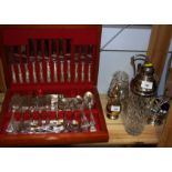 A cased canteen of silver plated King's pattern cutlery, a plate topped cocktail shaker, a plated