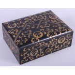 A Japanese Meiji period lacquered document box, decorated scrolled motifs and mons, 9" x 7"