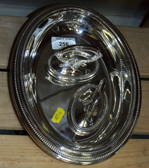 A pair of oval silver plated entree dishes and covers