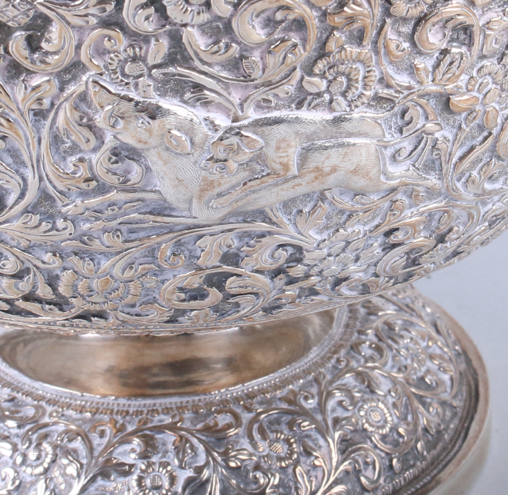 An Indian white metal pedestal fruit bowl, embossed and engraved with wild animals on a scrolled - Image 4 of 8