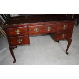 A mahogany writing desk, fitted five drawers, on cabriole supports, 48" wide