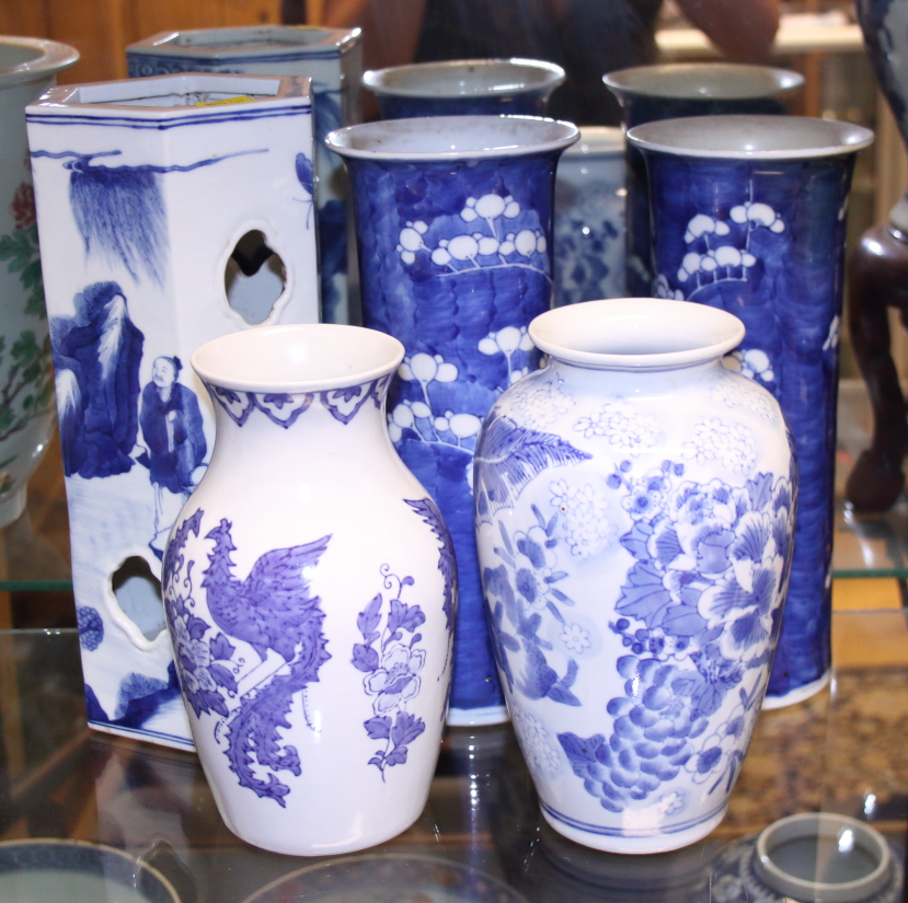 A pair of Chinese porcelain blue and white prunus decorated cylinder vases, 10" high, a floral