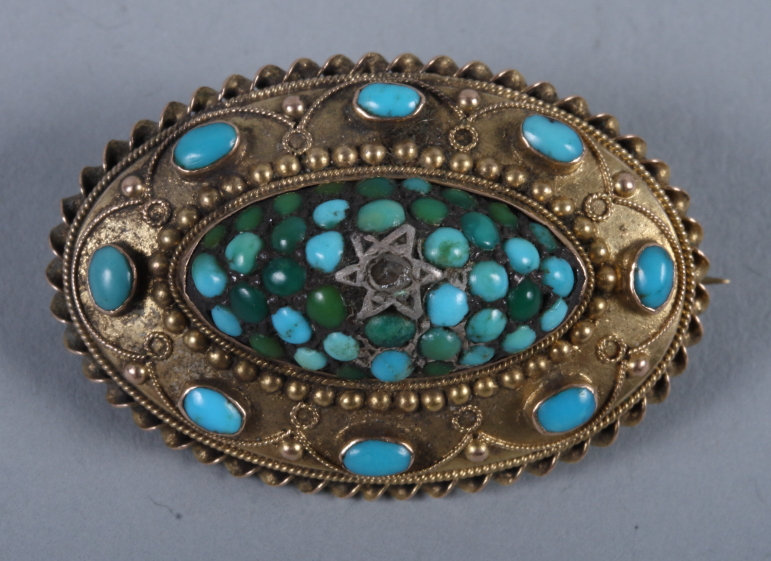 An early Victorian yellow metal Etruscan design oval brooch set with single diamond and turquoise