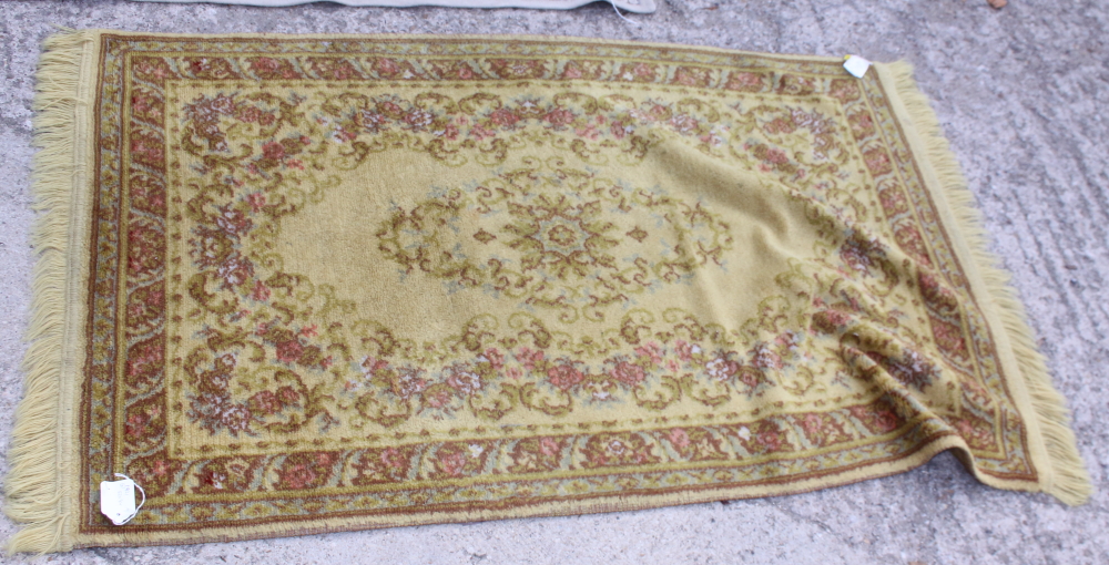 A Persian city design carpet with all-over scroll design on an ochre ground, 118" x 78" approx