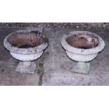 A pair of cast stone planters, on square bases, 17" wide
