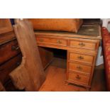 A stripped pine double pedestal desk with tooled lined top, fitted nine drawers, 50" wide