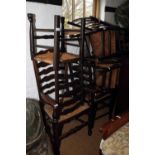 A harlequin set of ten oak ladder back chairs with rush envelope seats (2+8, +2)