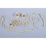 A carved ivory bead necklace with matching earrings, two similar necklaces, a fine bead necklace,