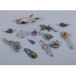 A Scottish silver mounted grouse foot brooch, various other silver and hardstone mounted brooches, a