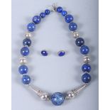 A silver and lapis bead necklace and a pair of matching ear studs
