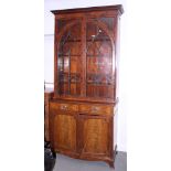 A mid 19th century mahogany book case, the upper section with Gothic lattice glazed arch top doors