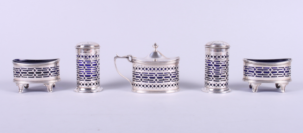 A 1920s silver and blue glass lined five-piece cruet set with pierced decoration