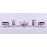 A 1920s silver and blue glass lined five-piece cruet set with pierced decoration