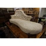 A mid Victorian carved walnut showframe chaise longue with serpentine seat rail, on cabriole
