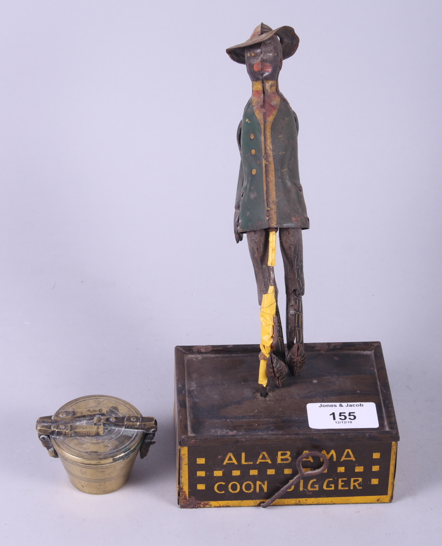 A tin-plate "Jigging" toy and a set of 19th century brass cup weights
