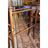 An Edwardian walnut and line inlaid towel rail, on splay supports, 26" wide