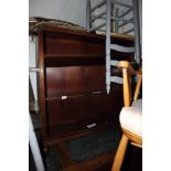 A mahogany three-shelf open bookcase, on four supports