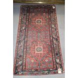 A Caucasian rug with two hooked guls on a pink ground, 29" x 52" approx