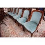 A set of six 19th century mahogany showframe dining chairs, upholstered in a turquoise velour, on