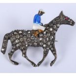 A silver enamel and brilliant set horse and jockey brooch