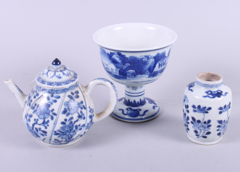 A Chinese porcelain blue and white landscape decorated stem cup, 4 1/2" high, a Kangxi vase, 3 1/