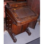 A late 19th century figured walnut and banded Davenport desk with fitted interior and four
