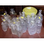 A large collection of cut glass decanters, perfume bottles and stoppers
