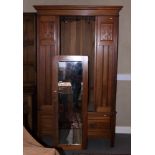 An Edwardian and walnut wardrobe, fitted one drawer and enclosed mirror panel door, by Whiteley,