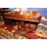 An early Victorian mahogany fold-over top card table, on faceted column and quadraform base, 36"