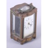 A brass shaped cased carriage clock, 5" high