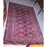 A Bokhara rug with sixteen guls in tradtitional shades, 85 1/2" x 51 1/2" approx